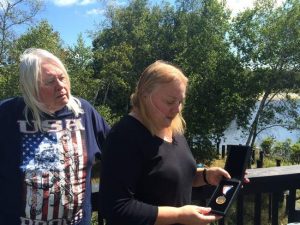 Buz and Kathy Whelan at their home in Long Pond, display Kathy's commemorative medal for her efforts on September 11, 2001. (Kevin Kunzmann/Pocono Record)